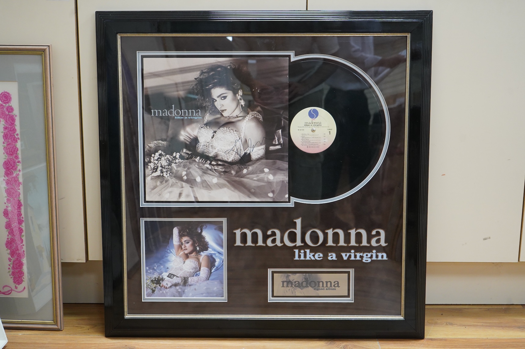 A signed and framed Madonna LP album, Like A Virgin, signed across the cover in black ink, well framed and mounted with an additional photograph and title, frame dimensions; 72.5 x 72cm